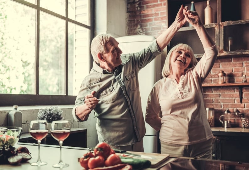 older adults dancing in kitchen