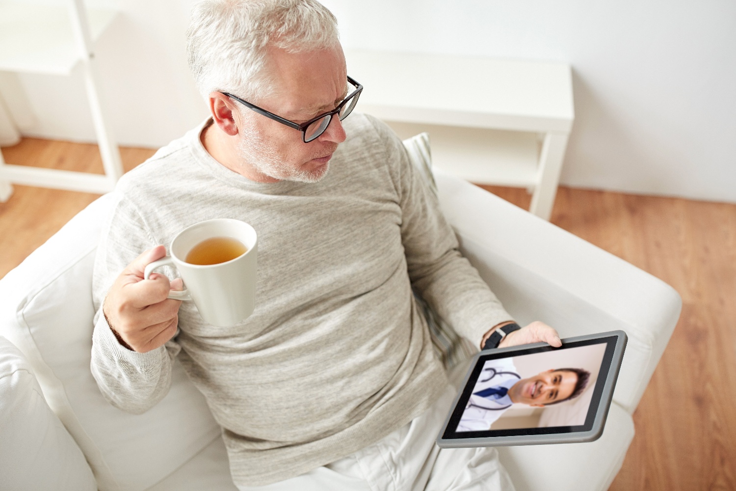 senior man using telehealth technology