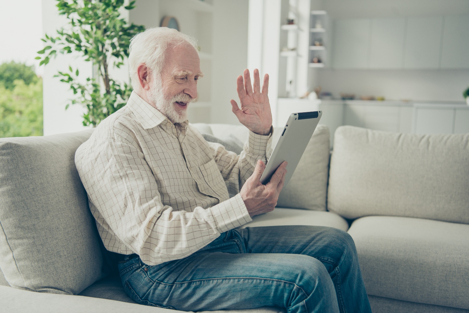 older adult man video chatting with family