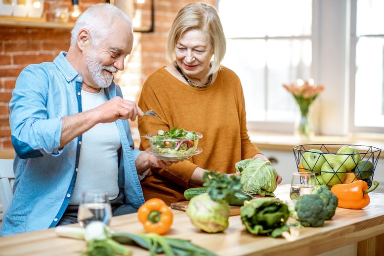 senior couple cooking healthy food