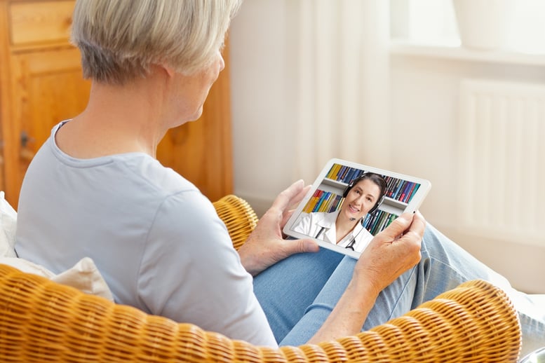 older woman using telehealth technology