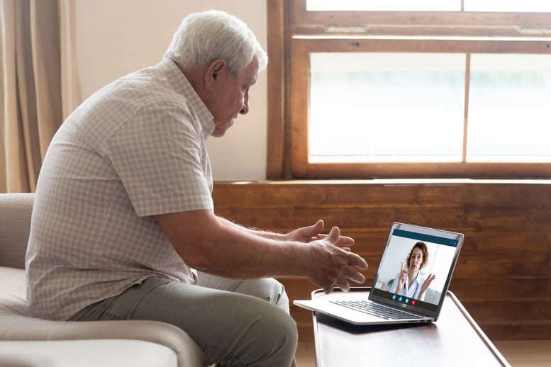 older adult using telehealth technology