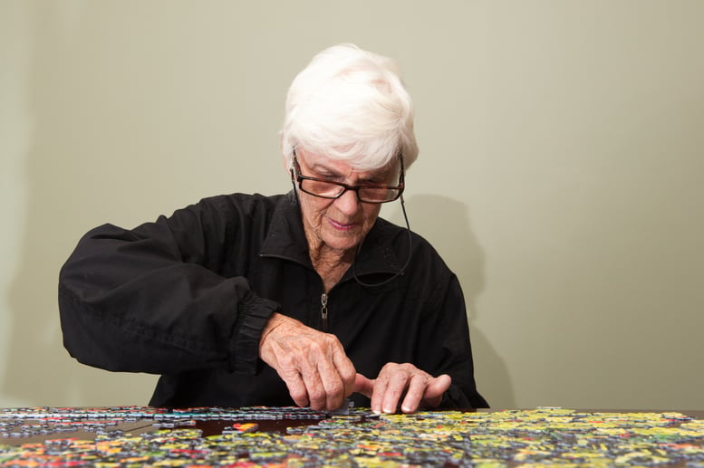 senior woman doing puzzle