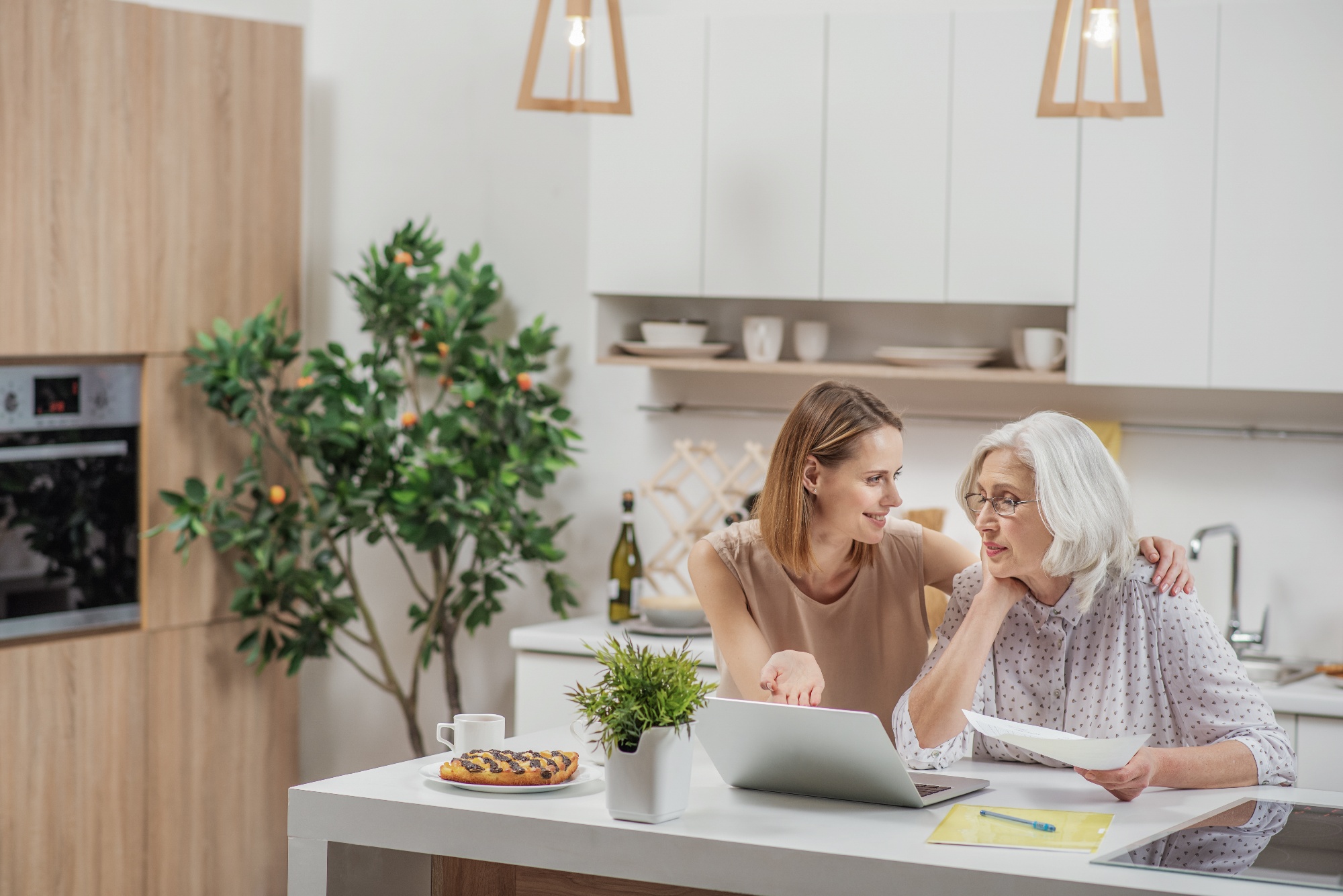 daughter talking things through with elderly mother